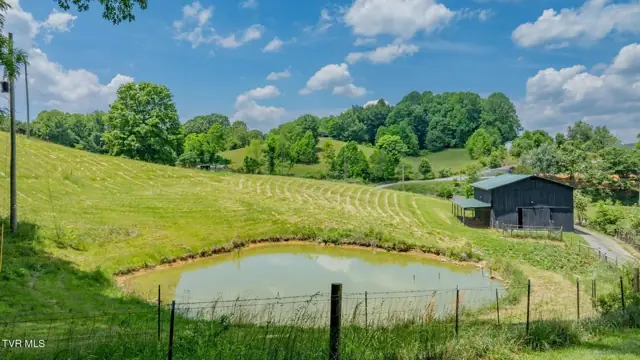 Farm pond with the barn and pasture beyond